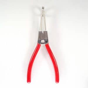 Hoof It cattle claw spreader shown upright with pointed prongs, spring pivot and open red handles